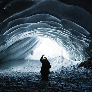 Woman taking photo in an ice cave  